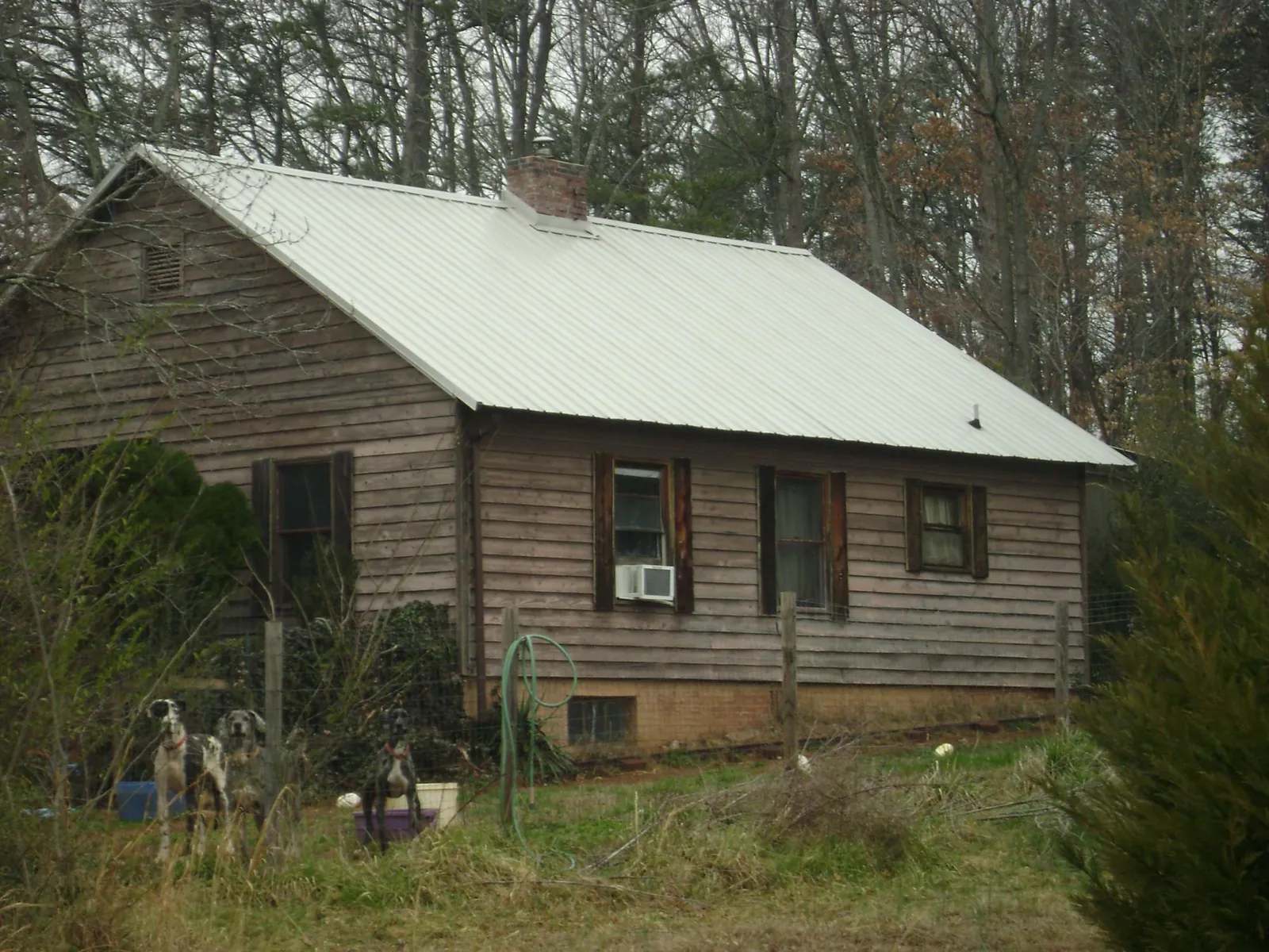 White metal roof on an old wood sided farmhouse, from a Metal Roof Installation job in Mays Landing
